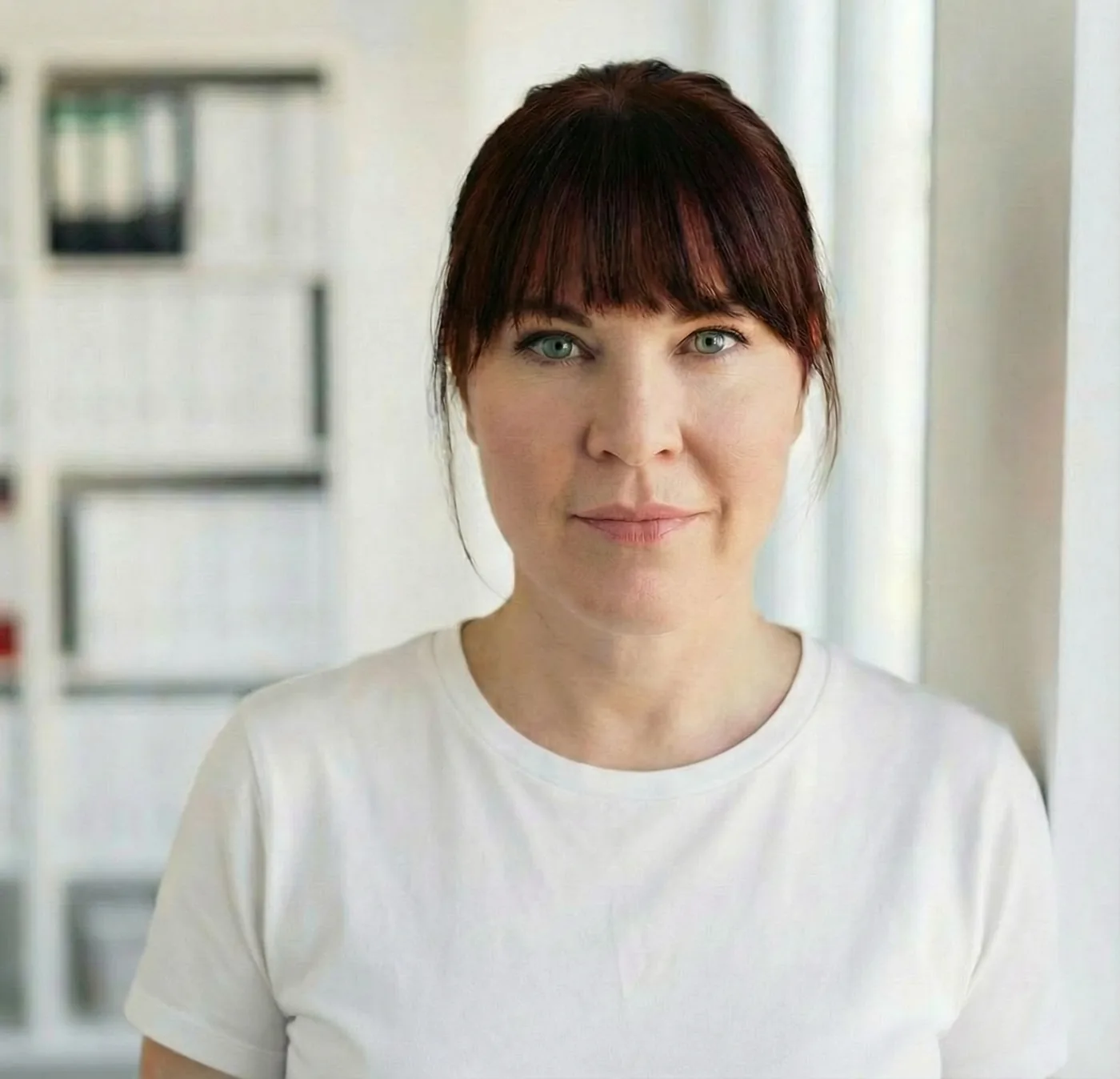 Marion Wetter — Porträt im Büro vor weißer Wand